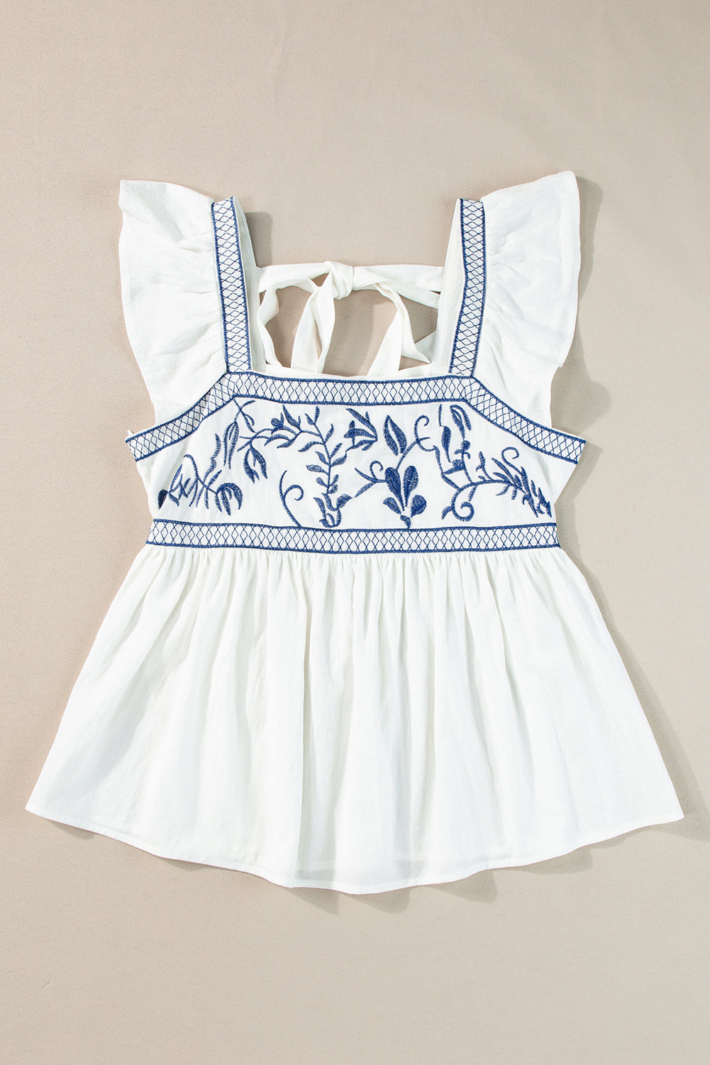 White with Blue Embroidered Bust Ruffled Sleeveless Tied Back Peplum Top