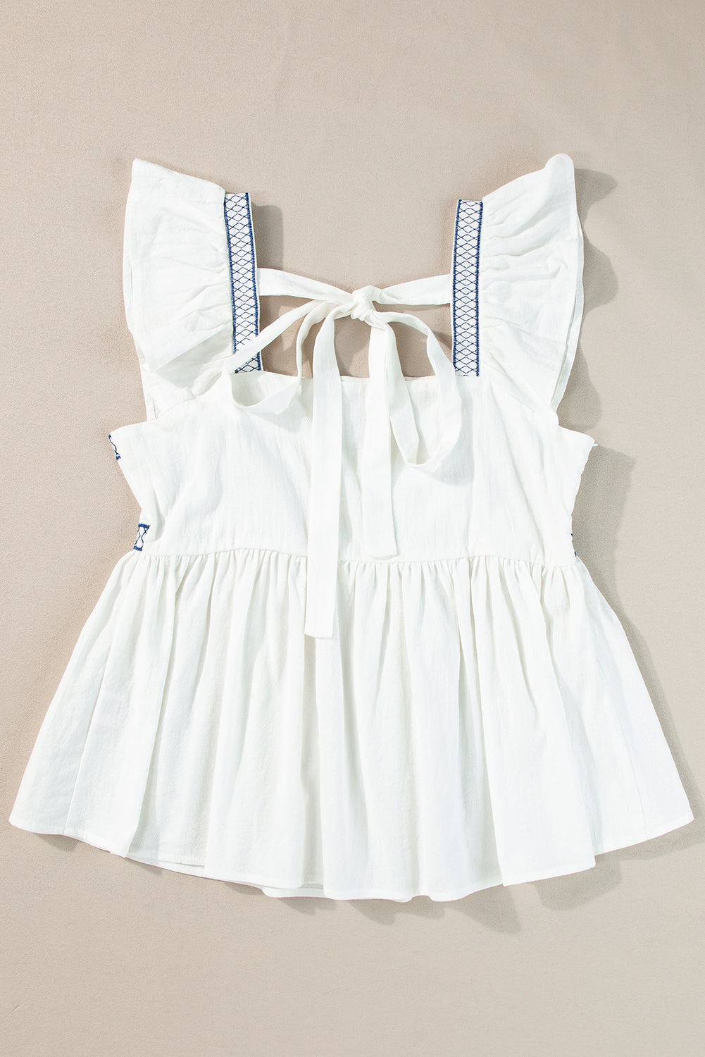 White with Blue Embroidered Bust Ruffled Sleeveless Tied Back Peplum Top