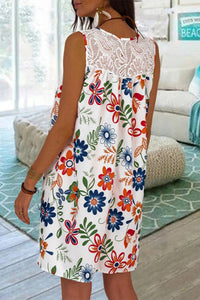 White sleeveless sundress with simple floral print of dark blues, greens, and orange colors. Features a classic round neckline detailed with lace. This casual dress is airy and comfortable that sits just above the knee with a loose hemline. This is roomy for sizes!! 