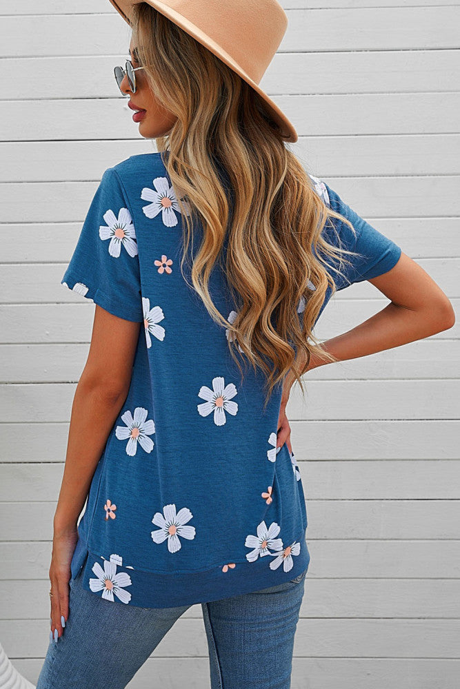 Solid blue tee with white daisy prints. This tee is soft, lightweight and very comfy to wear. Round neck, short sleeve, loose fit with side slits. This short sleeve top is perfect for any summer occasion Pair it with our daisy shorts and jeans! Runs True to Size.